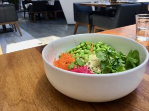 Rice bowl with edamame, carrots, pickled veggies and cilantro.