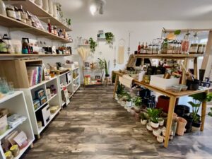 The kitchen section of the store. Tables and shelves are holding cookbooks, chocolate, gifts, glassware and more.