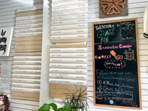 Menu board with prices at Grass Fed Vegan Butcher.