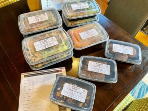 7 meals from Sweet Pea Plant-Based Kitchen along with muffins, brownies, and granola bars.