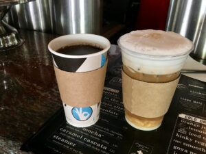 Hot coffee and an iced latte on top of a Java's menu