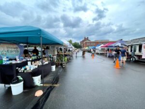 Brighton Farmers Market vendors selling goods on a rainy Sunday