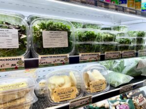 Assorted local Microgreens and mushrooms in a cooler at Lori's Natural Foods.