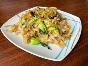 Asian dish with bok choy and cabbage, handmade noodles and cumin spice.