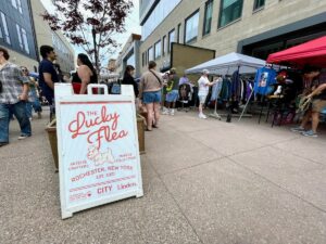 Lucky Flea sign with vendors in the background
