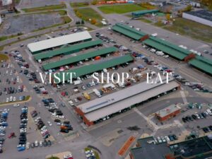 Birdseye view of the market with the words "Visit. Shop. Eat" overlayed