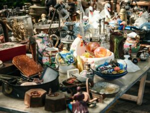 Antique items on a table at a thrift sale.