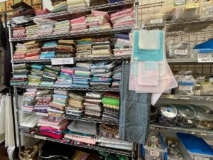 Shelves of fabric at SewGreen Rochester