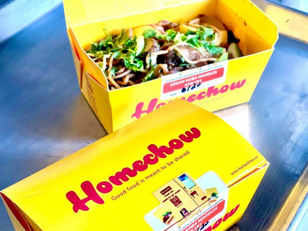 One closed box and one open box showing the vegan soba noodle stir fry.