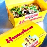 One closed box and one open box showing the vegan soba noodle stir fry.