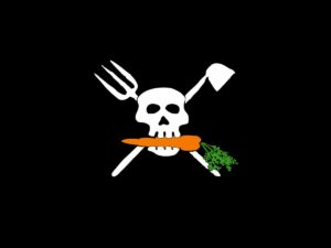 Farmer Pirates logo, a skull with a carrot in its mouth, with a pitch fork and hoe forming an X behind the skull