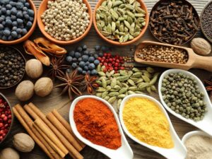 A variety of bulk spices in different size dishes on a table